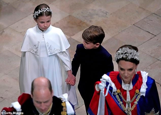 97047721-14584429-Charlotte_takes_her_brother_s_hand_as_they_follow_their_parents_-m-23_1744198009761.jpg